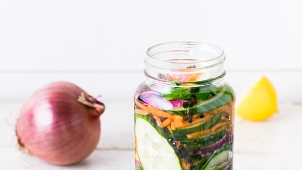 jar of fermented veggies, onion and lemon on table