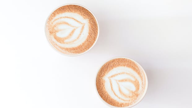two cafe lattes against a white background