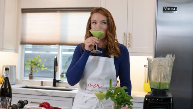 Laura Klein sips chilled melon soup from a martini glass