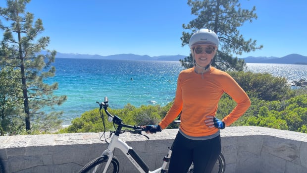 Laura Klein stands with e-bike at Lake Tahoe