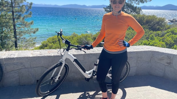 Laura Klein stands with e-bike at Lake Tahoe
