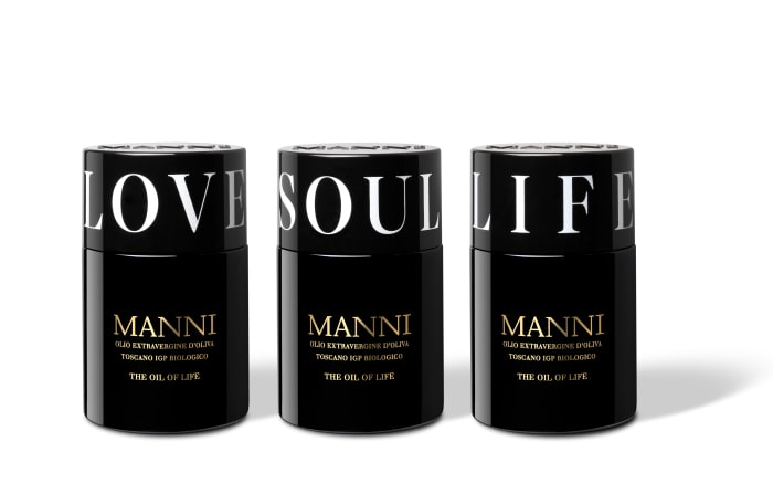 Manni Extra Virgin Olive Oil in black bottles with Love, Soul and Life caps.