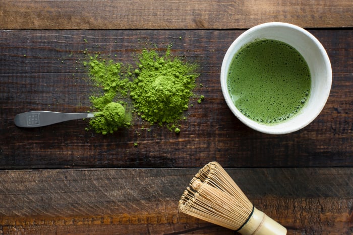 green tea and brown fat production, image of matcha tea in cup with whisk