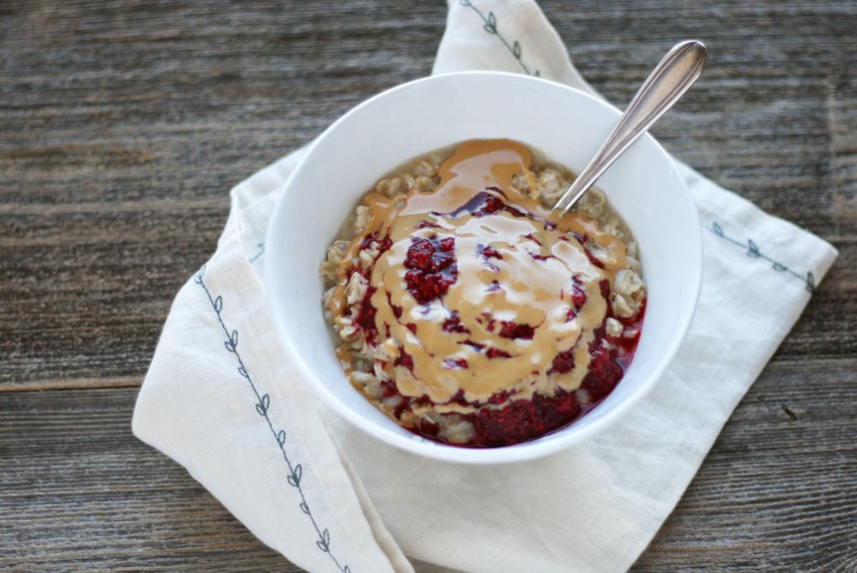 how to cook oatmeal breakfast garnished with toppings of jam and nut butter