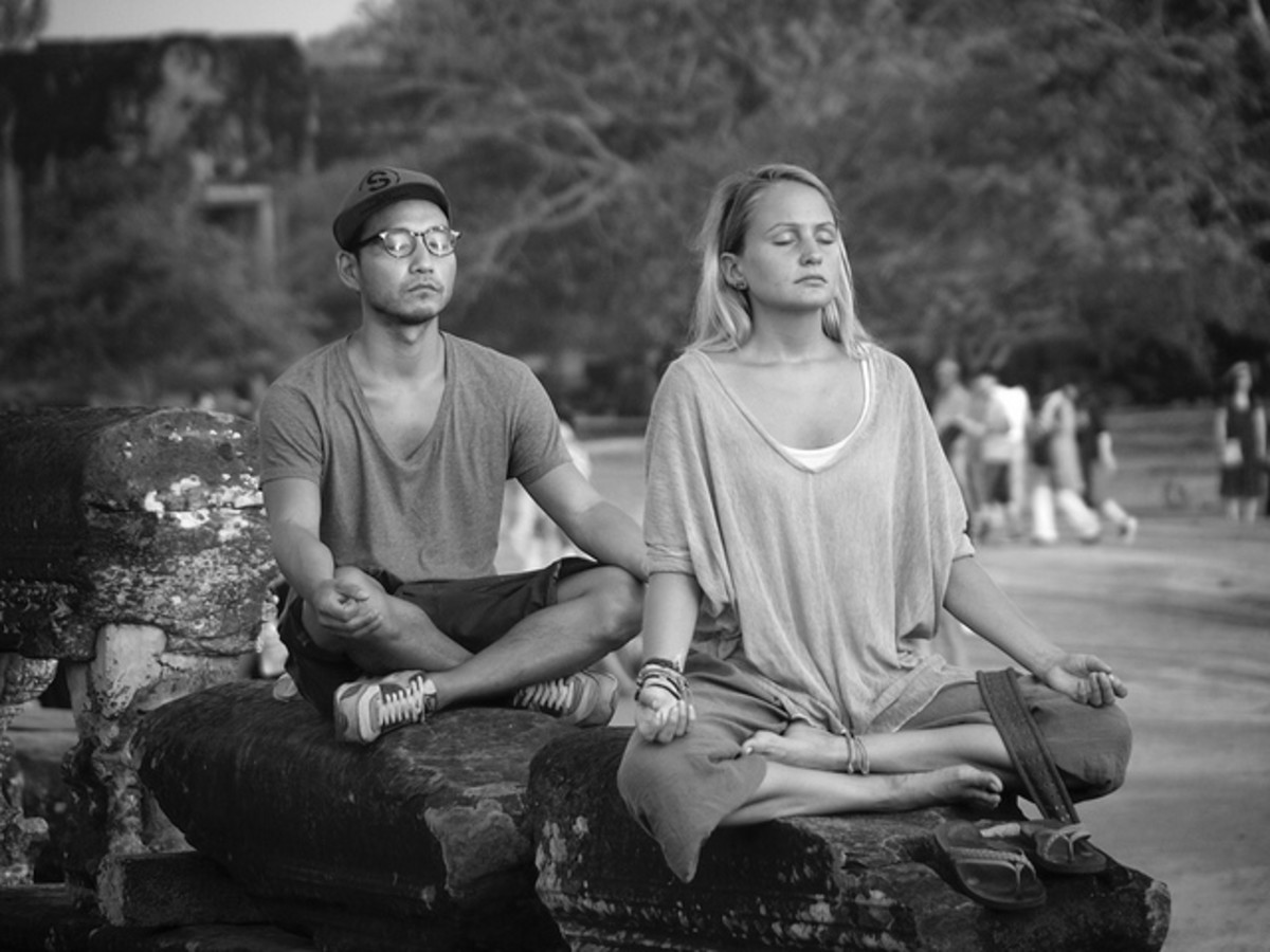 Two people meditating.