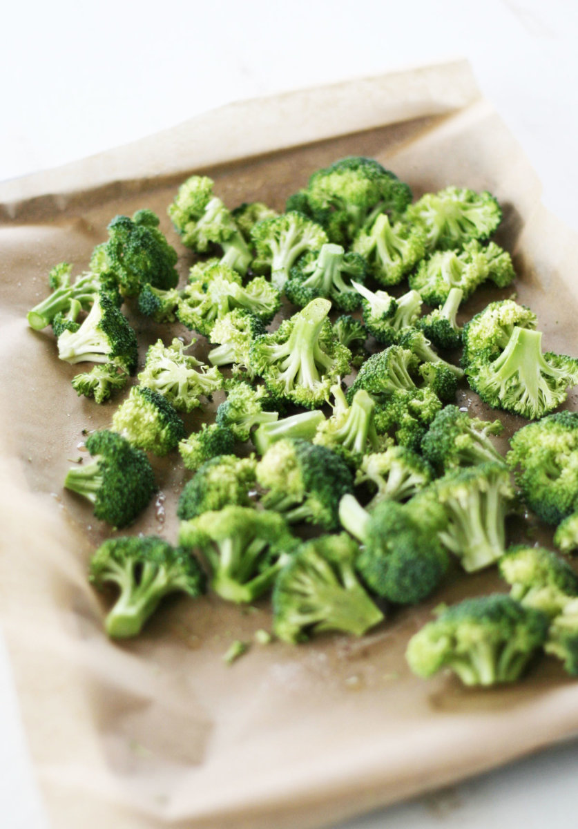 how to roast broccoli. Broccoli on a sheet pan with parchment paper