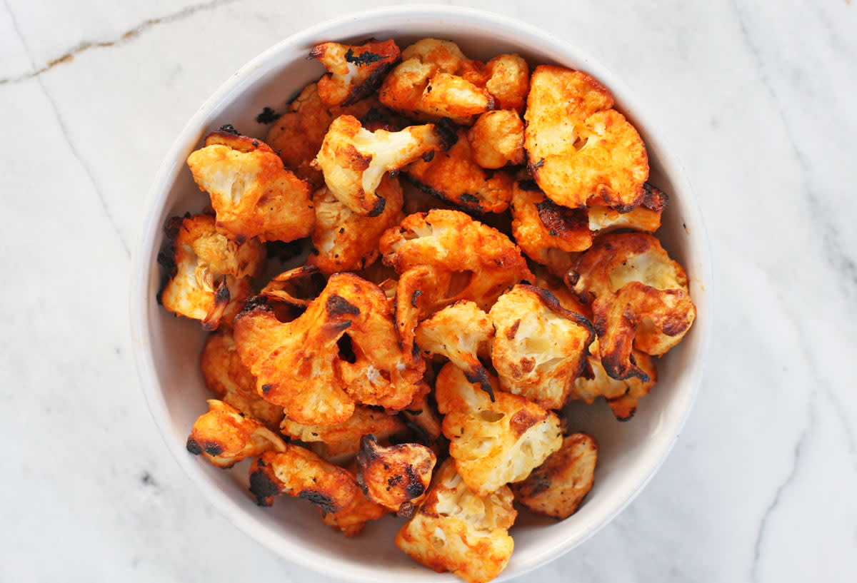 Delicious and healthy cauliflower hot wings in a white bowl.