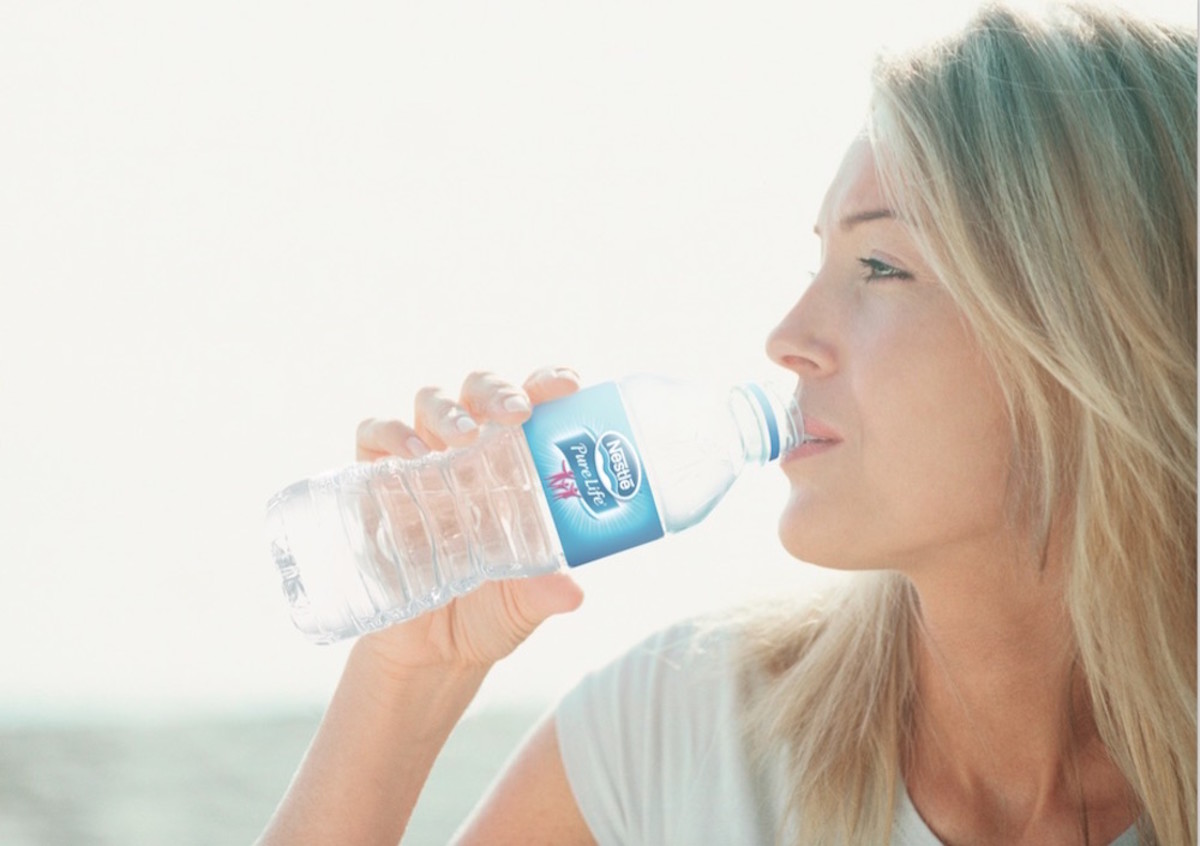 nestle-pure-life_drinking_caucasian_woman_outdoor_water_consumption copy
