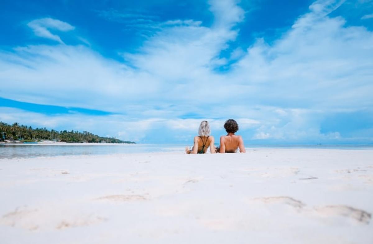 Couple on the beach soaking in Grand Velas Riviera Maya on Mexico’s Caribbean Coast Wellness Getaway