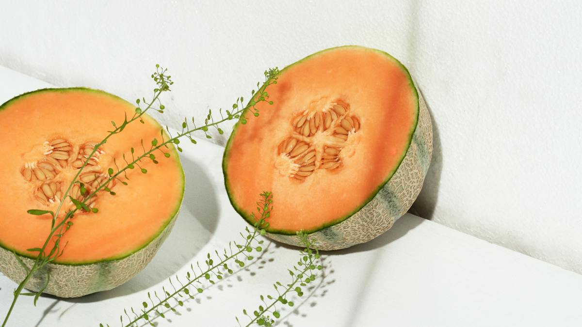 Cantaloupe cut in half with herb over it