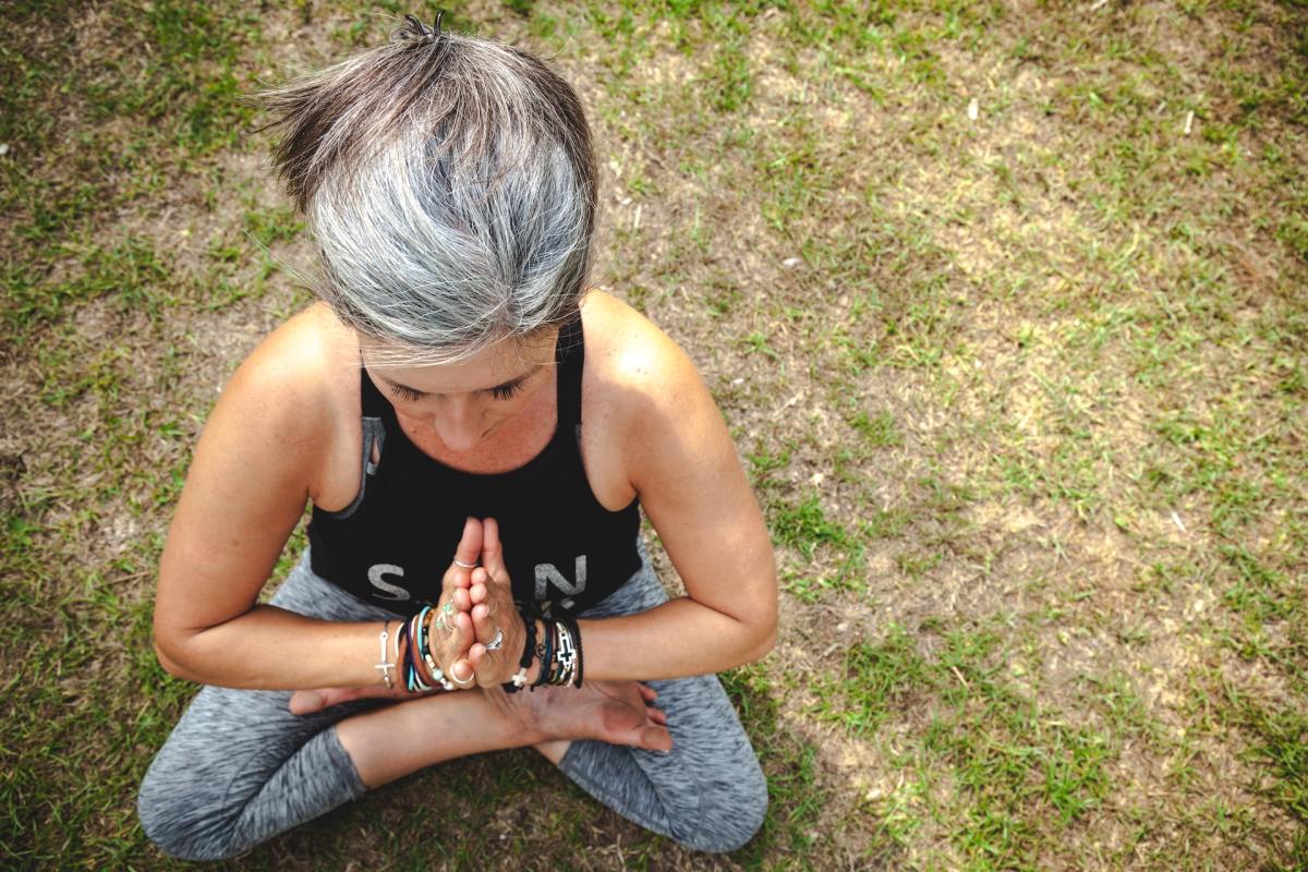 woman doing yoga with gray hair
