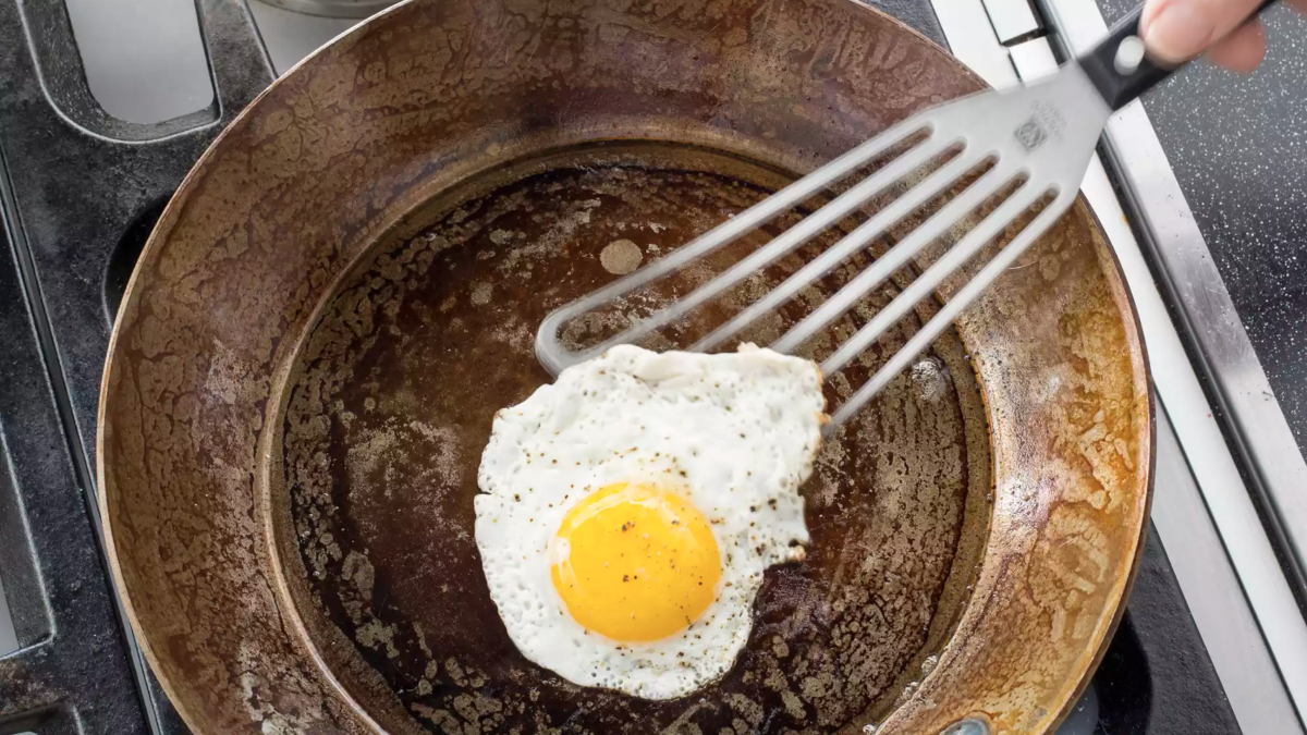 Carbon steel pan with an egg in it.