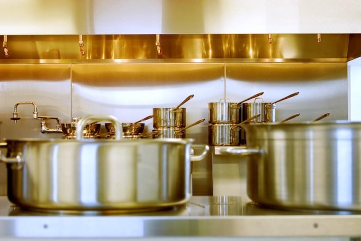 Stainless steel pots and pans in a restaurant kitchen.