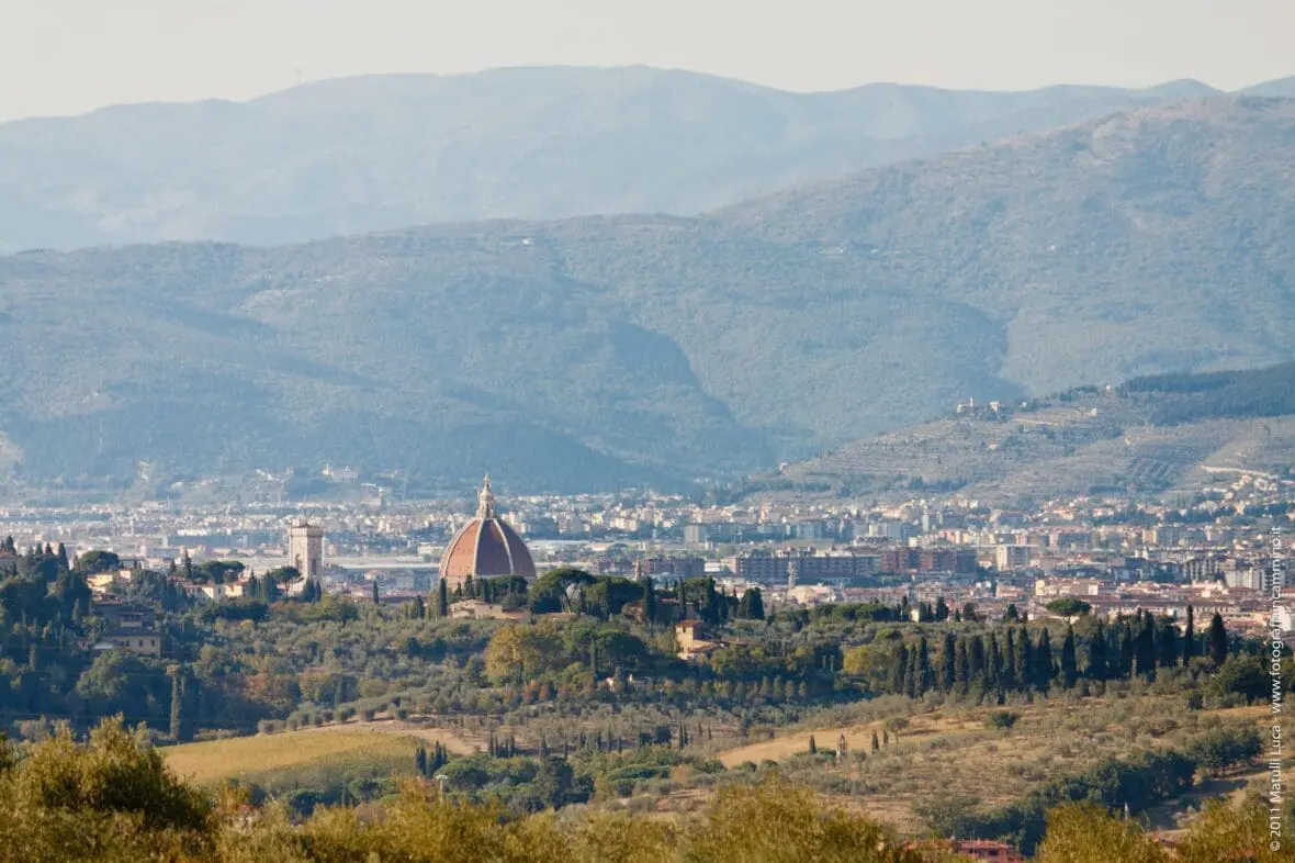 Florence cathedral dome rising above the Tuscan countryside and hills