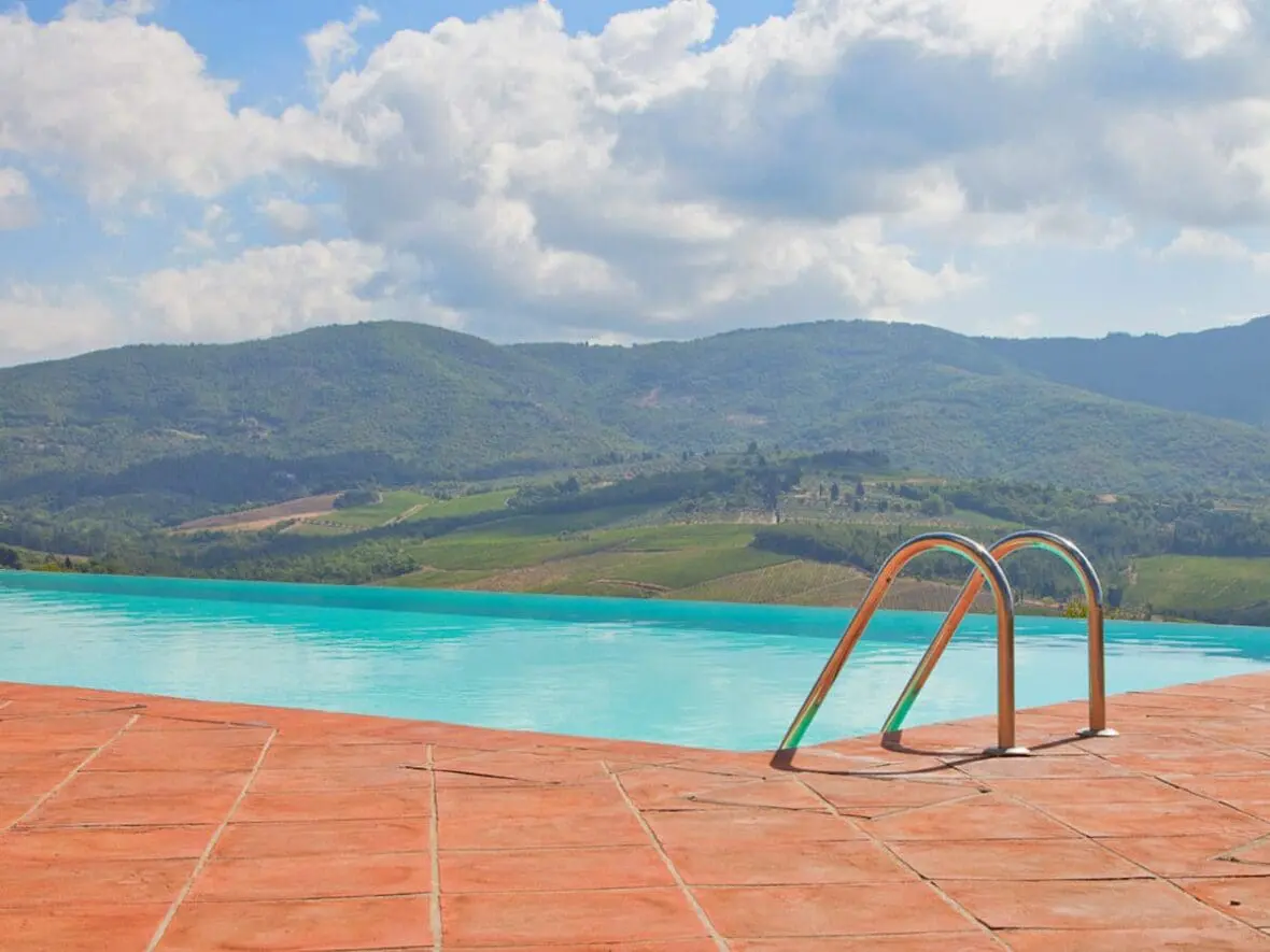 Infinity pool overlooking Tuscan vineyards and rolling hills
