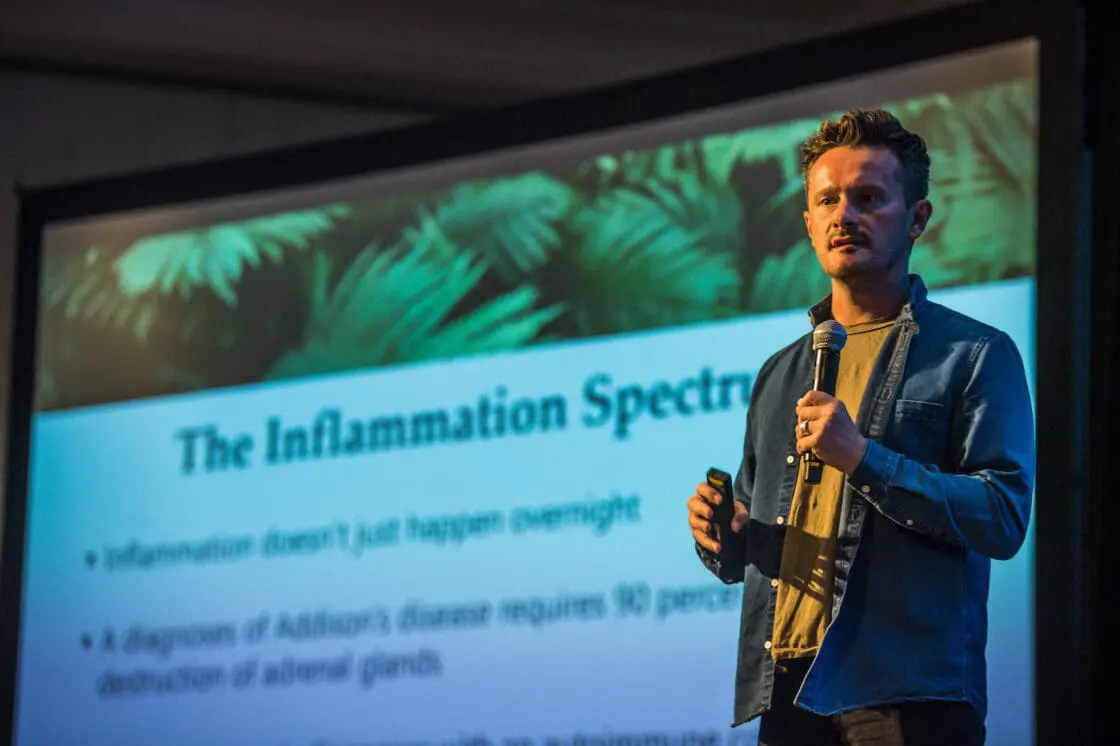 Speaker presenting on inflammation spectrum at wellness conference