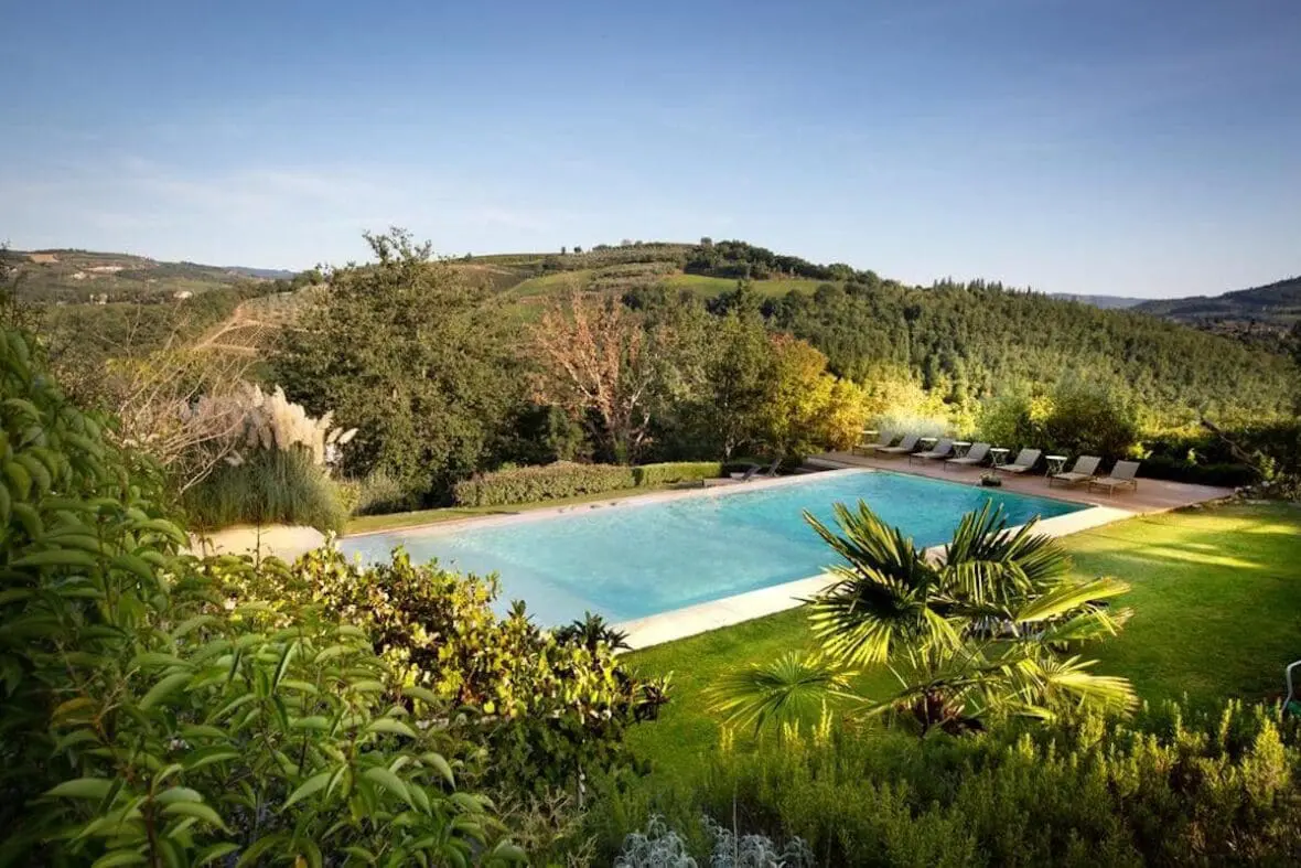 Swimming pool overlooking vineyard hills at an Italian wine estate hotel