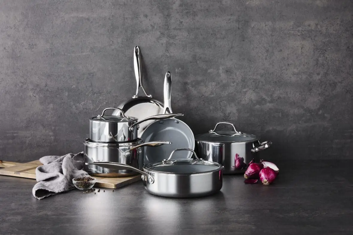 Image of the Valencia Pro Stainless Steel 10-piece set, with a gorgeous high-shine finish on a dark countertop set against a dark background.