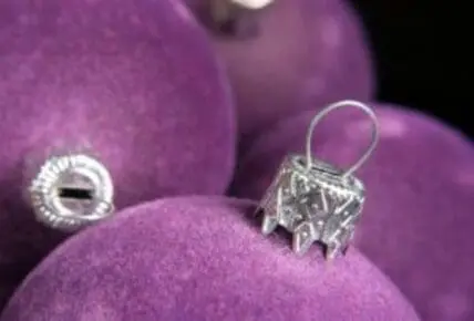 Silver ornament on purple velvet Christmas baubles