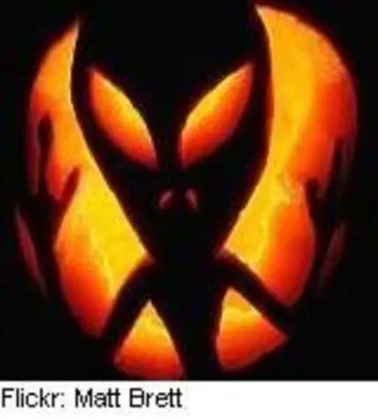 Glowing jack-o'-lantern face carved into a pumpkin against dark background
