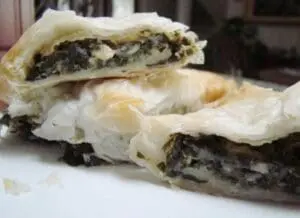 Spinach and feta phyllo pastry cut in half to show the layered filling