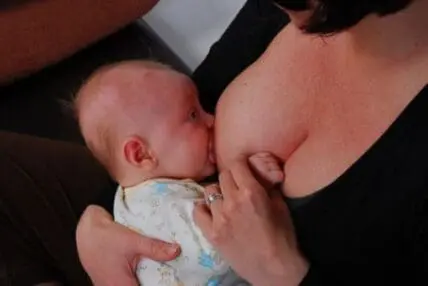 A mother breastfeeding her infant baby