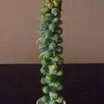 Tall decorative tower made of Brussels sprouts topped with a gold star