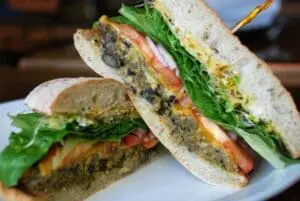 Vegetable patty sandwiches with lettuce and tomato on seeded rolls