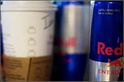 Three energy drink cans including Red Bull displayed side by side