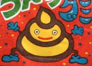 Cheerful cartoon poop character with brown coloring and yellow smile on red background