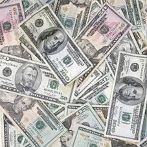 Scattered U.S. dollar bills of various denominations