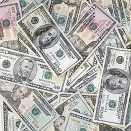 Scattered U.S. dollar bills of various denominations