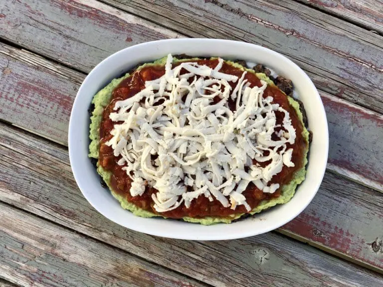 image of cheese on top of other layers for the 5 layer black bean mexican dip that goes over like gangbusters at any gathering or party.