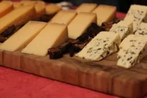 Assorted artisanal cheeses arranged on a wooden board
