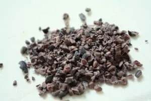 Pile of cocoa nibs on a white surface