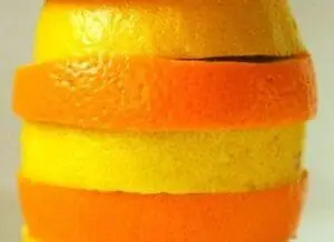 Stacked slices of lemon and orange peels showing yellow and orange citrus rinds