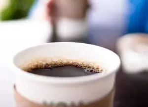 Close-up of black coffee in a white cup with crema