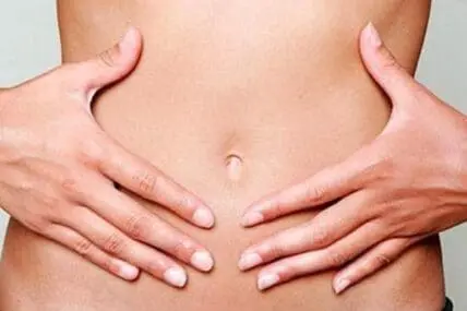 Person's hands placed on bare abdomen