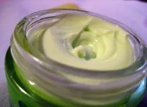 Creamy pale green cupuaçu seed butter in a glass jar