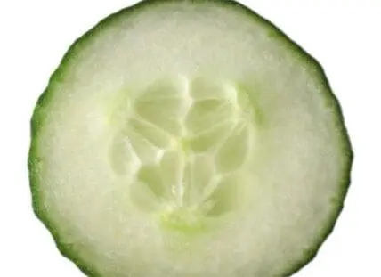 Cross-section of a fresh cucumber showing seeds and inner flesh