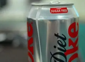 A silver can of diet soda with a red label and "Sugar Free" badge visible