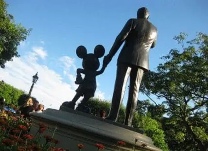 Statue of Walt Disney holding hands with Mickey Mouse at Disneyland
