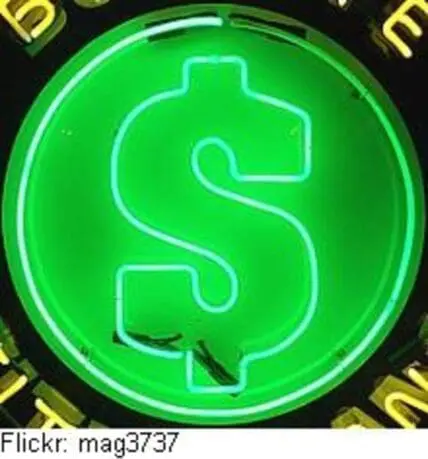 Green neon dollar sign symbol on dark background