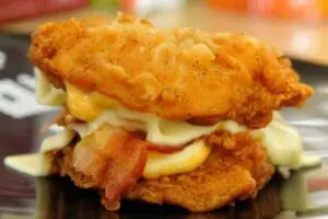 Crispy fried chicken sandwich with cheese and bacon
