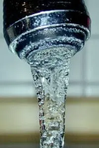 Clear water flowing from a faucet aerator