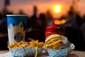 Fast food meal with burger, fries, and drink at sunset