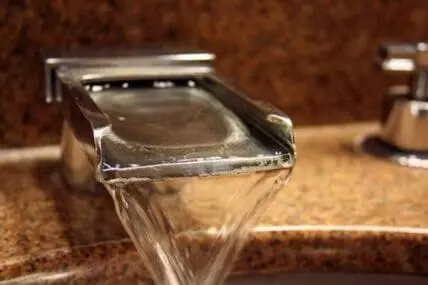 Close-up of water flowing from a tap or faucet