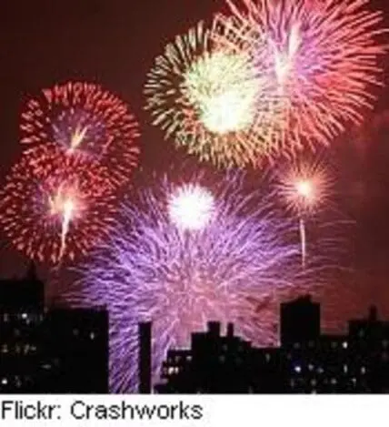 Colorful fireworks exploding over a city skyline at night