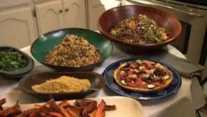 Plant-based meals including quinoa, vegetables, and plant-based protein arranged on kitchen counter