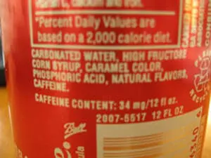 Nutrition label showing high fructose corn syrup listed in ingredients on beverage bottle